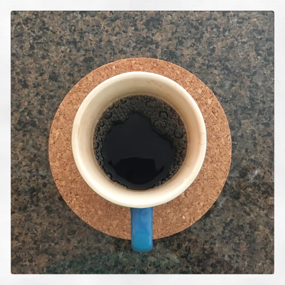 A blue mug filled with coffee.